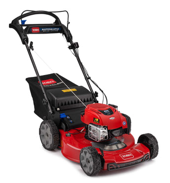 A red self-propelled lawn mower with a black collection bag, labeled 'TORO', and a B&S engine. Greenstripe